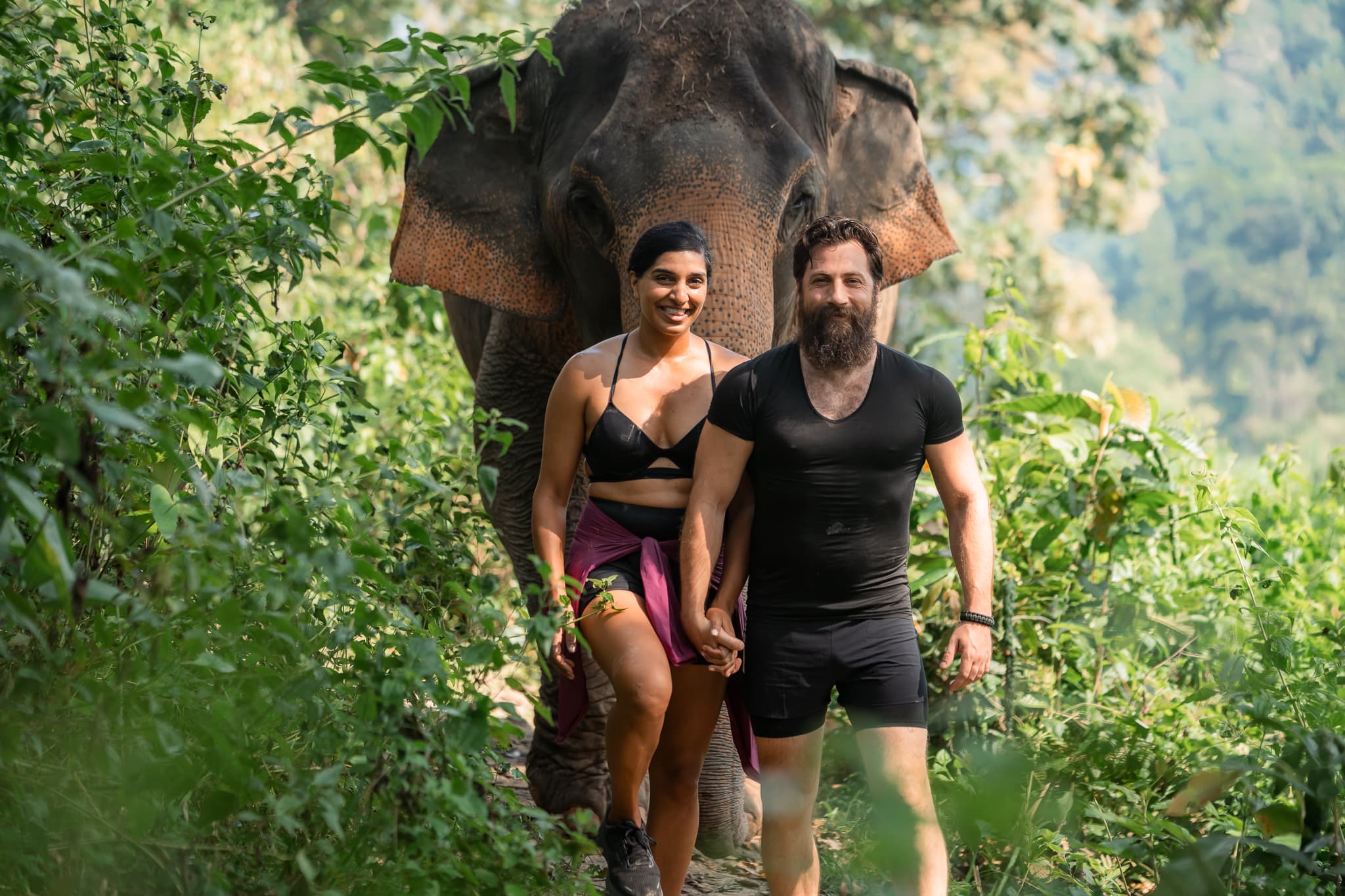 Devin and Kamana walking through the jungle